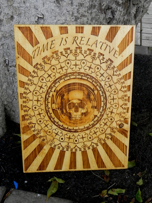 “Time is Relative ” by Diego Scaglia Rat, laser engraved on pine wood, 11,8” x 15,7 “