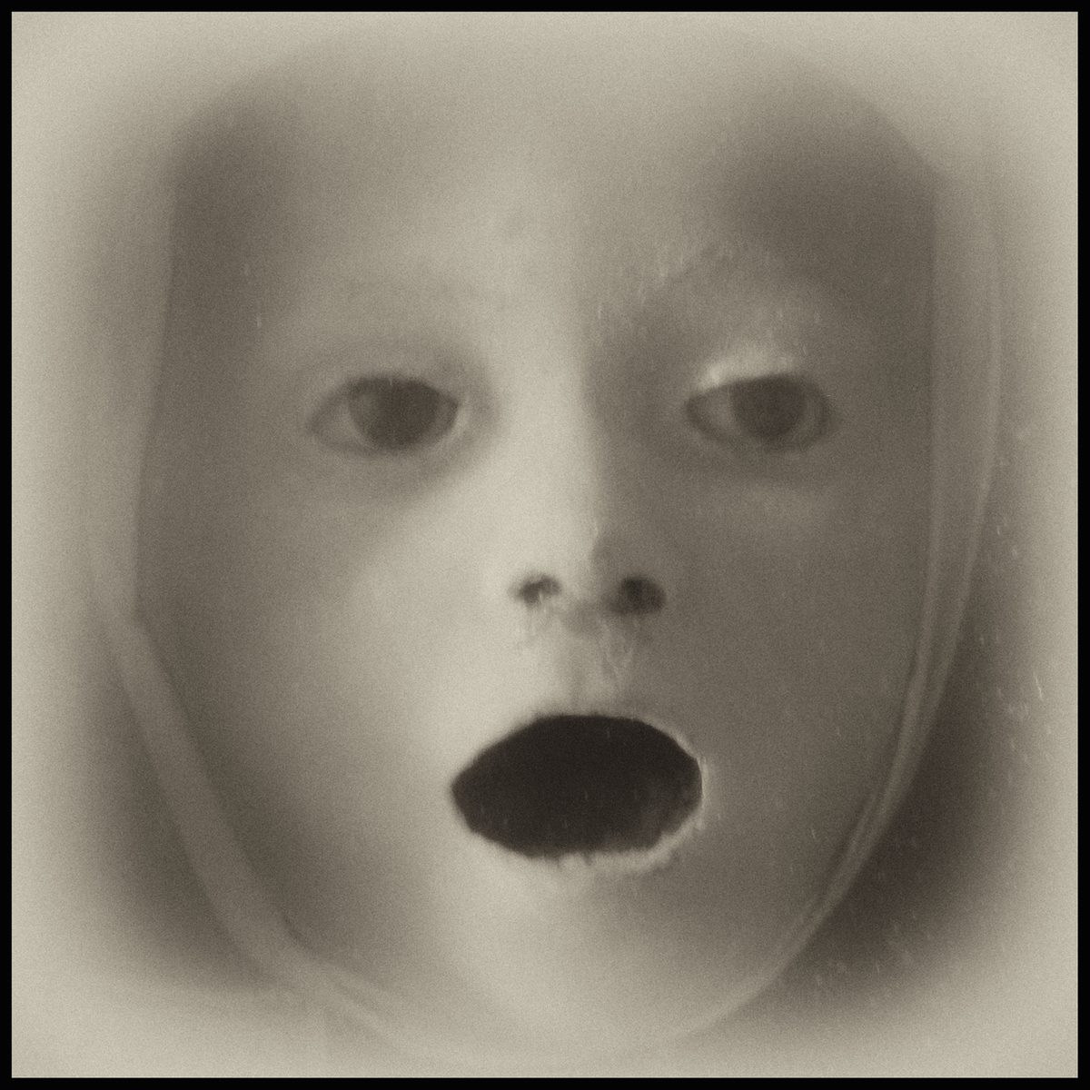 Surreal close-up of a pale face with an open mouth, from Armageddon by Augusto De Luca