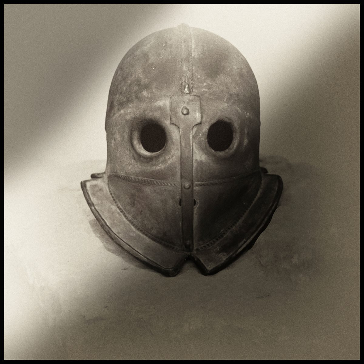 Vintage diving mask with round eye openings in a surreal monochrome photograph by Augusto De Luca